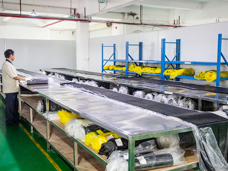 Rubber material preparation area with stainless steel worktables and wrapped material rolls
