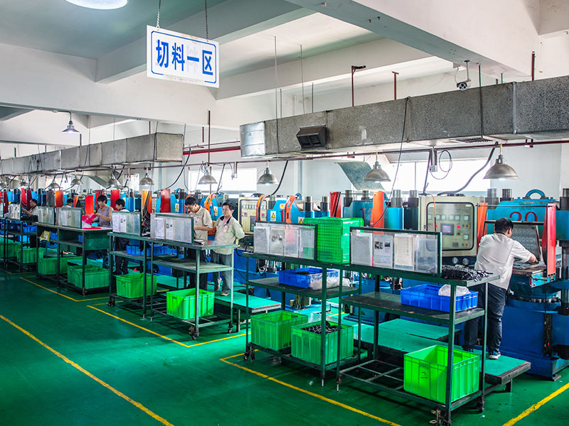 Rubber material cutting workshop with industrial processing machines and operators